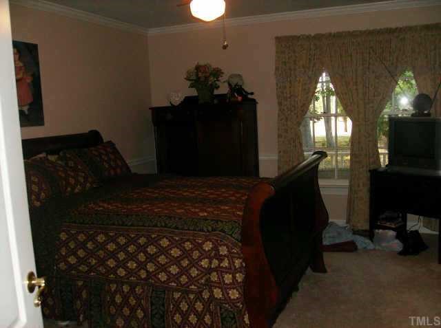 301 Hesters Store Road Roxboro, NC 27574 - Photo 6 of 6 a bedroom with a bed dresser and a mirror