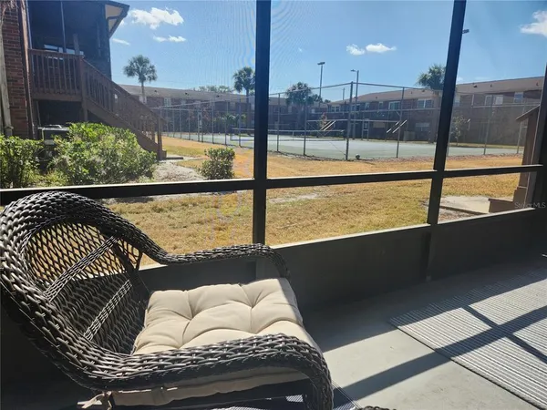 a living room with a floor to ceiling window and deck