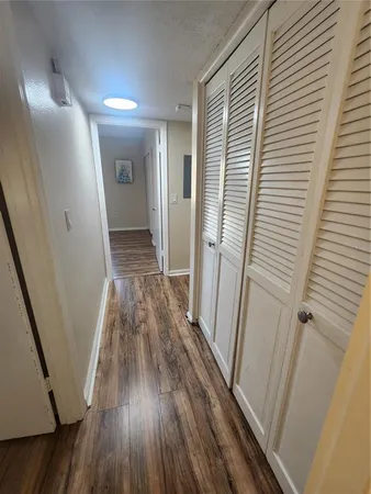 a view of a hallway view with wooden floor and staircase