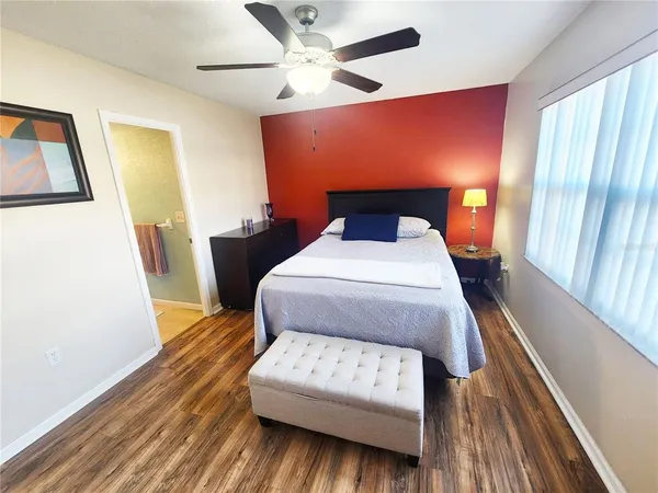 a bed sitting in a bedroom next to a window