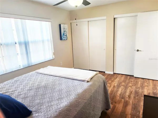 a bedroom with a bed and a window