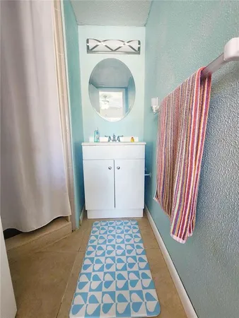 a bathroom with a sink a mirror and a shower curtain