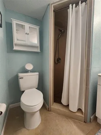 a white toilet sitting next to a bathroom sink