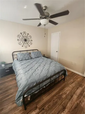 a bedroom with a bed and wooden floor