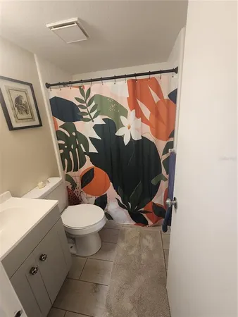 a bathroom with a sink mirror vanity and toilet