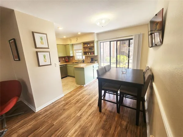 a dining room with furniture and wooden floor
