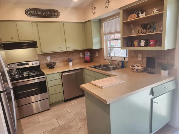 a kitchen with a sink cabinets and appliances