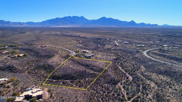 a view of a mountain range with lush green forest