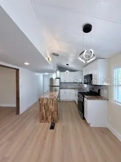 a kitchen with a refrigerator and a sink