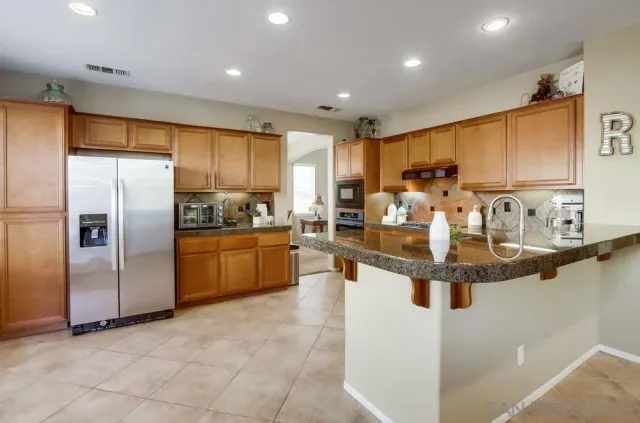 a kitchen with stainless steel appliances granite countertop a sink and cabinets