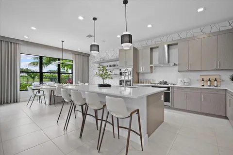 a kitchen with stainless steel appliances granite countertop a stove a sink a kitchen island with a dining table and chairs