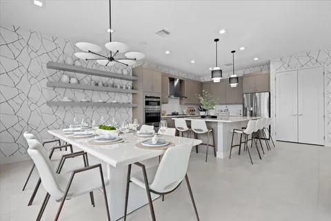 a large kitchen with a table and chairs