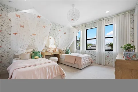 a bedroom with a large bed a flat tv screen and a dresser