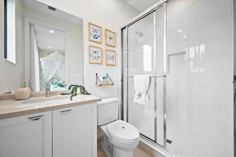 a spacious bedroom with a bed and a flat screen tv