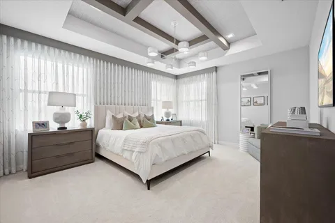 a walk in closet with clothes and shoes