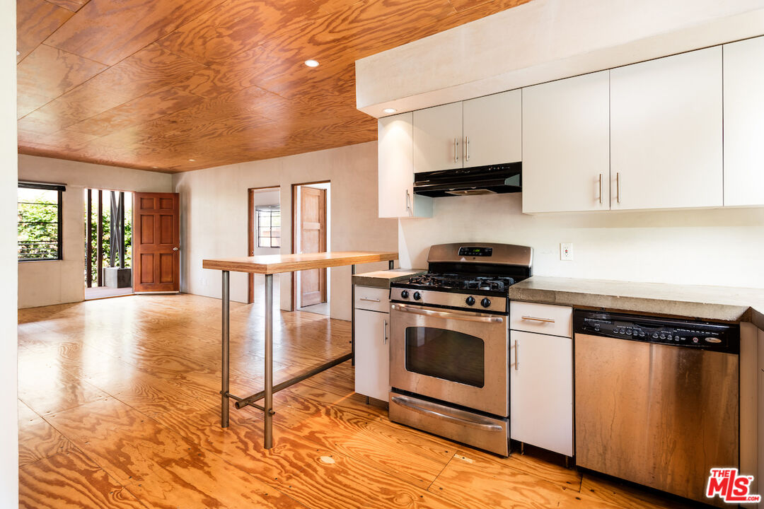 325 Indiana Avenue, Unit 2 Venice, CA 90291 - Photo 1 of 7 a kitchen with stainless steel appliances granite countertop a stove a sink and a microwave