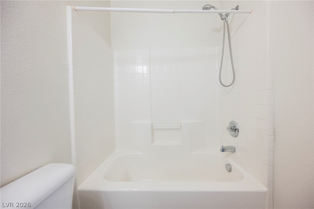 6320 Snap Ridge Street, Unit 201 North Las Vegas, NV 89081 - Photo 34 of 56 A pristine bath and shower combo offers a clean, inviting space for daily refreshment.