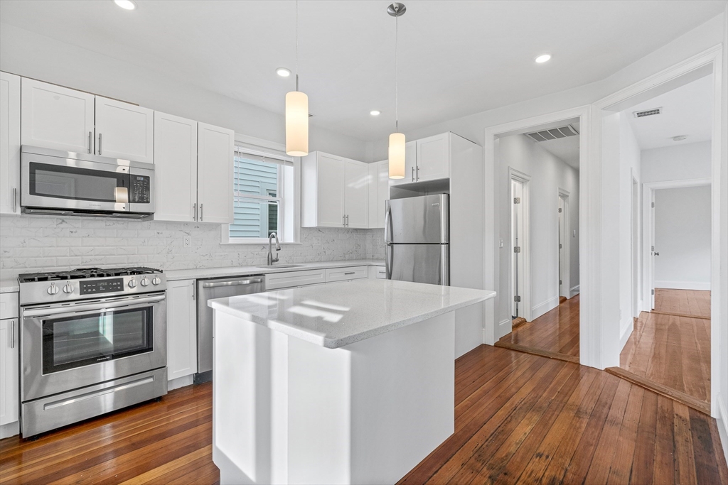 307 Hancock Street, Unit 3 Boston, MA 02125 - Photo 1 of 25 a kitchen with stainless steel appliances granite countertop a stove a sink and a refrigerator