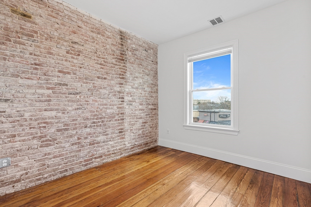 307 Hancock Street, Unit 3 Boston, MA 02125 - Photo 11 of 25 a view of an empty room and wooden floor