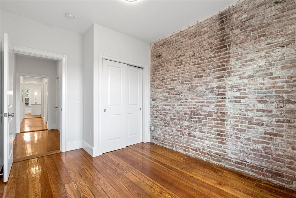 307 Hancock Street, Unit 3 Boston, MA 02125 - Photo 12 of 25 a view of empty room with wooden floor