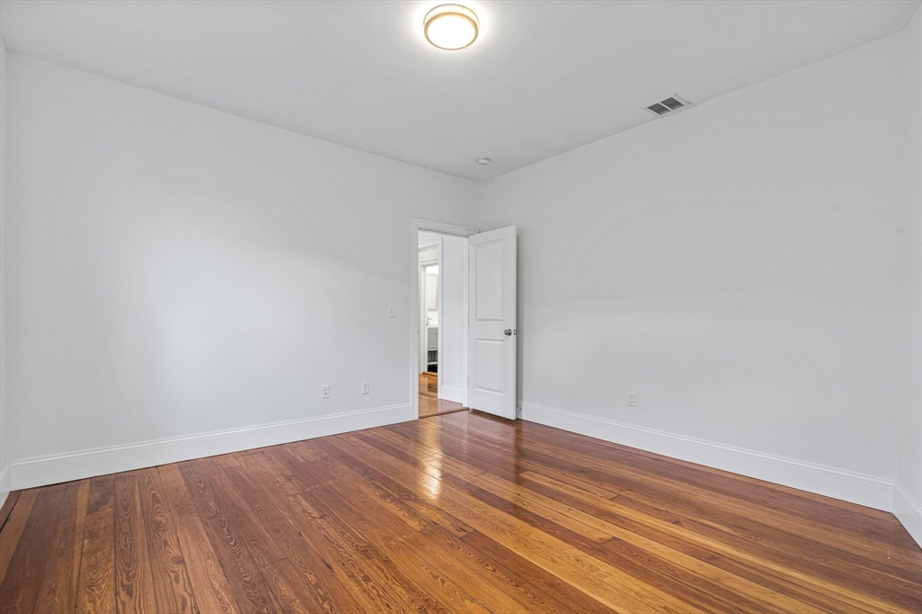 307 Hancock Street, Unit 3 Boston, MA 02125 - Photo 15 of 25 a view of an empty room and wooden floor