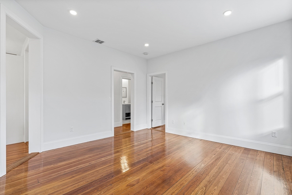 307 Hancock Street, Unit 3 Boston, MA 02125 - Photo 18 of 25 a view of an empty room with wooden floor