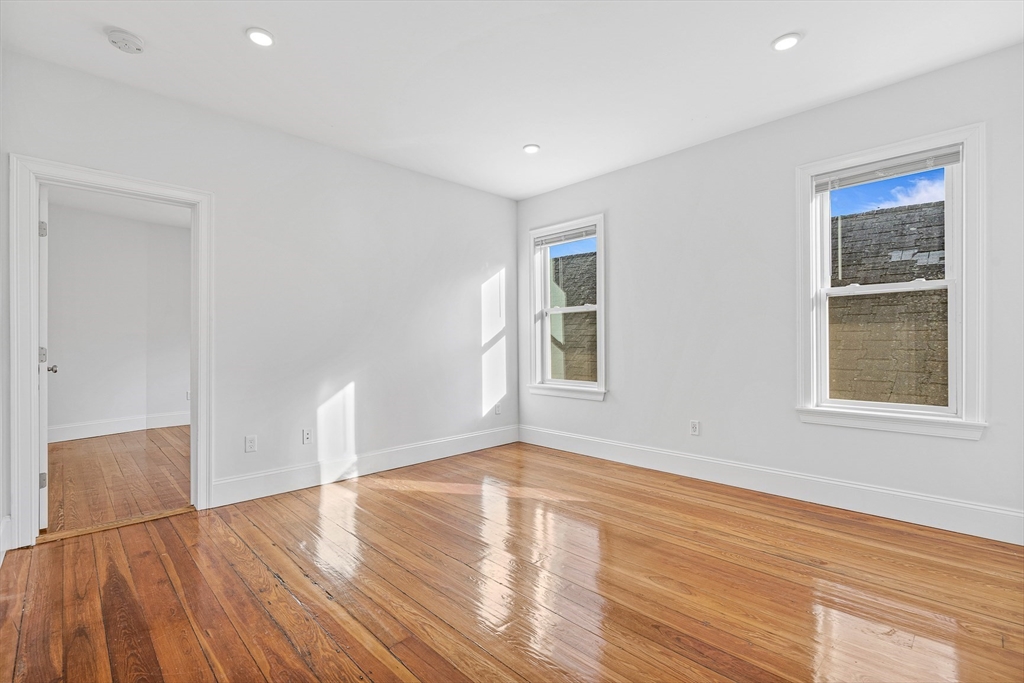 307 Hancock Street, Unit 3 Boston, MA 02125 - Photo 19 of 25 a view of empty room with wooden floor and fan