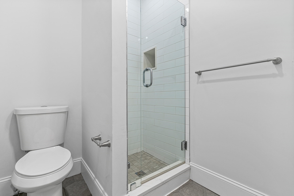 307 Hancock Street, Unit 3 Boston, MA 02125 - Photo 23 of 25 a bathroom with a shower and toilet