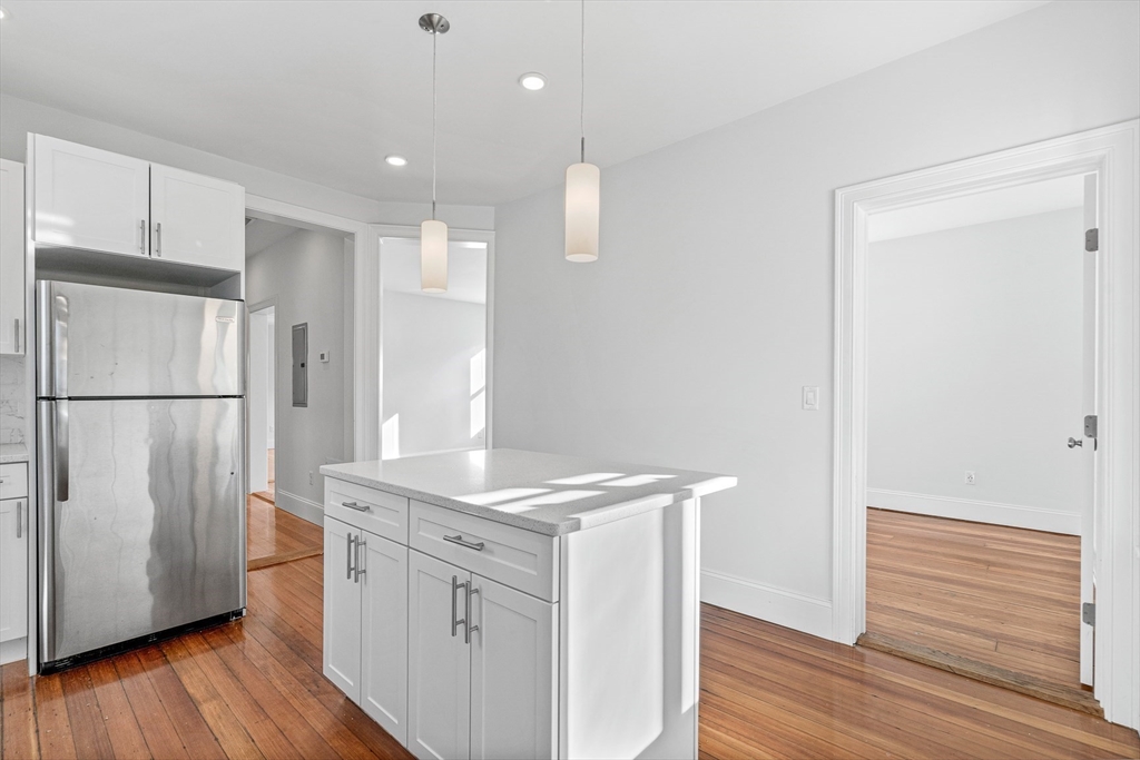 307 Hancock Street, Unit 3 Boston, MA 02125 - Photo 4 of 25 a kitchen with a refrigerator sink and cabinets