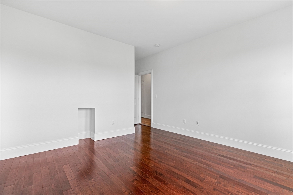 307 Hancock Street, Unit 3 Boston, MA 02125 - Photo 9 of 25 an empty room with wooden floor