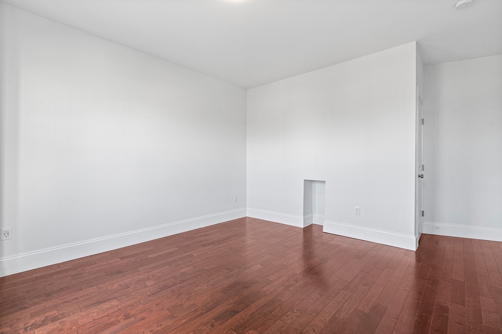 307 Hancock Street, Unit 3 Boston, MA 02125 - Photo 10 of 25 a view of empty room with wooden floor