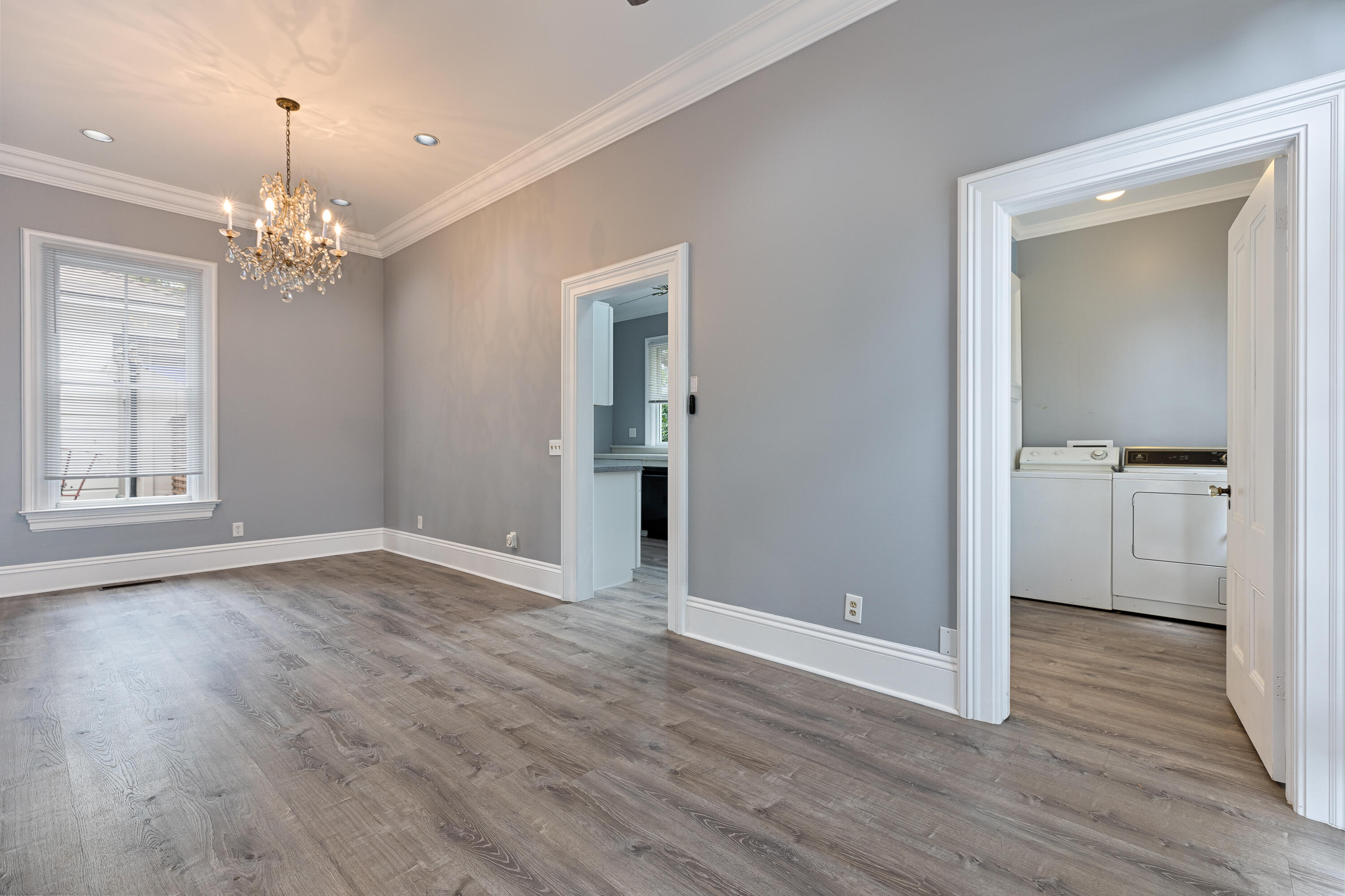 533 Brinkerhoff Avenue Santa Barbara, CA 93101 - Photo 18 of 27 a view of an empty room with wooden floor and a kitchen