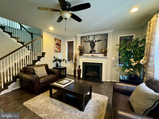 a living room with furniture a window and a flat screen tv