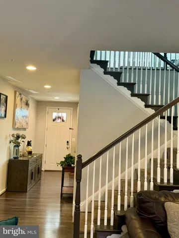 a living room with furniture and a ceiling fan