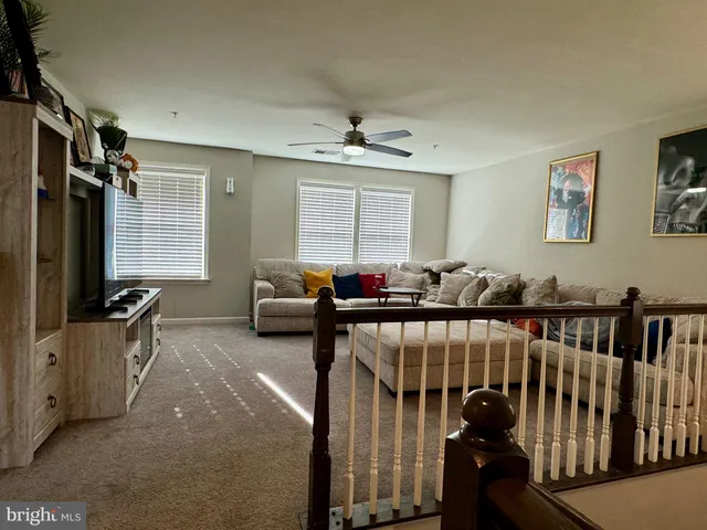 a living room with furniture cabinets and a window