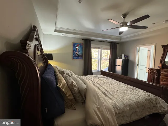 a bedroom with a bed dresser and a window