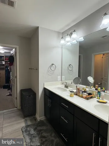 a spacious bedroom with a bed and a chandelier