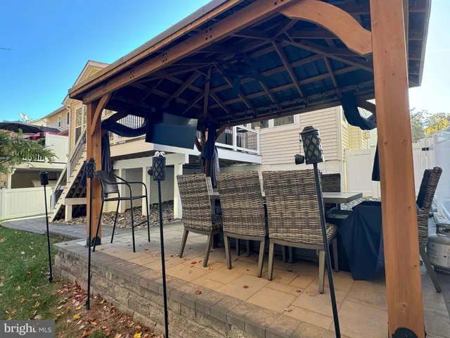 a view of a terrace with couches and a fireplace