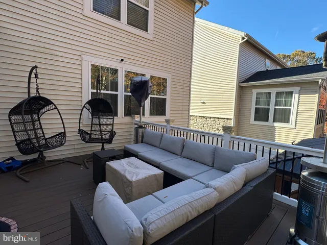 a view of a patio with dining table and chairs