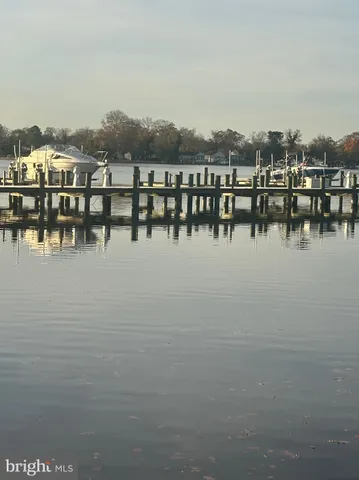 a view of a wooden bench sitting in front of a house