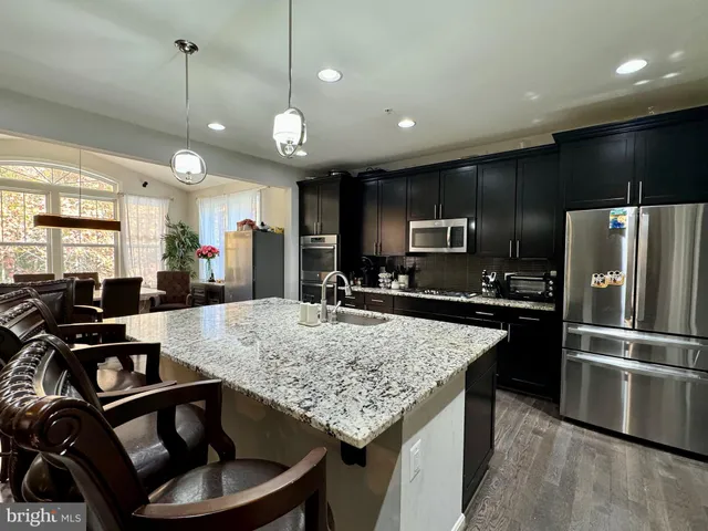 a kitchen with sink stove and refrigerator