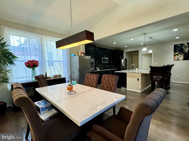 a kitchen with stainless steel appliances granite countertop a sink a stove and a refrigerator