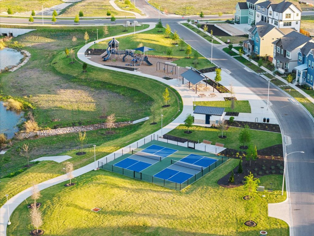 9015 Cattle Baron Path, Unit 705 Austin, TX 78747 - Photo 34 of 35 an aerial view of residential houses with outdoor space and swimming pool