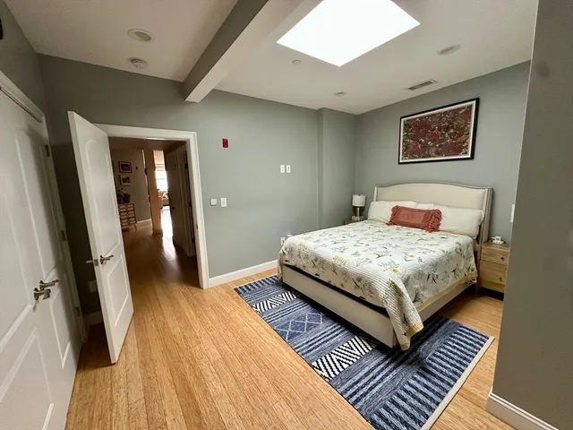 a bedroom with a bed and wooden floor