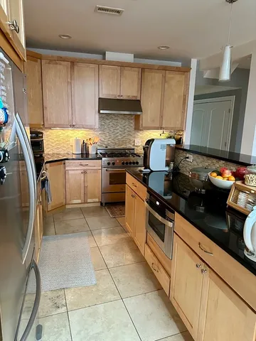 a kitchen with a sink a stove and refrigerator