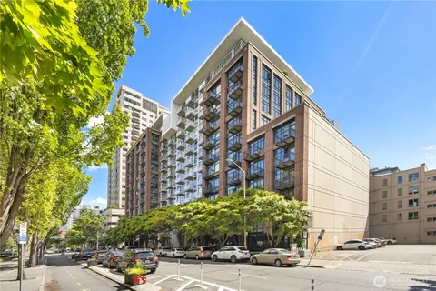 a view of a tall building next to a road