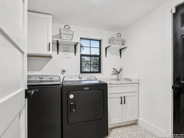 a utility room with sink dryer and washer
