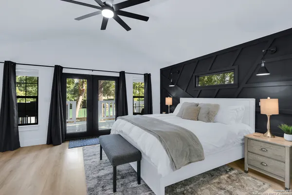 a bedroom with a large bed and a large window