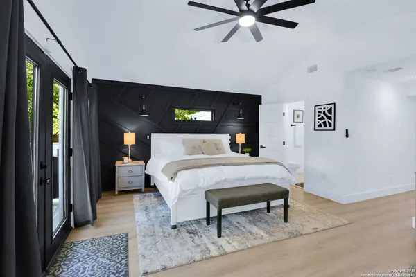 a bed sitting in a bedroom next to a window