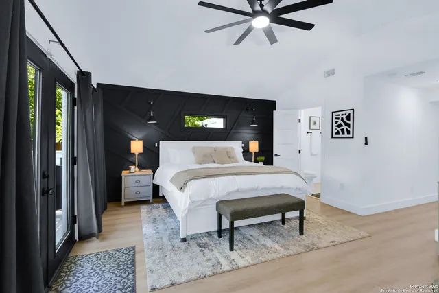 a bed sitting in a bedroom next to a window